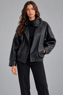 Women's oversized black faux leather bomber jacket, front view with funnel collar