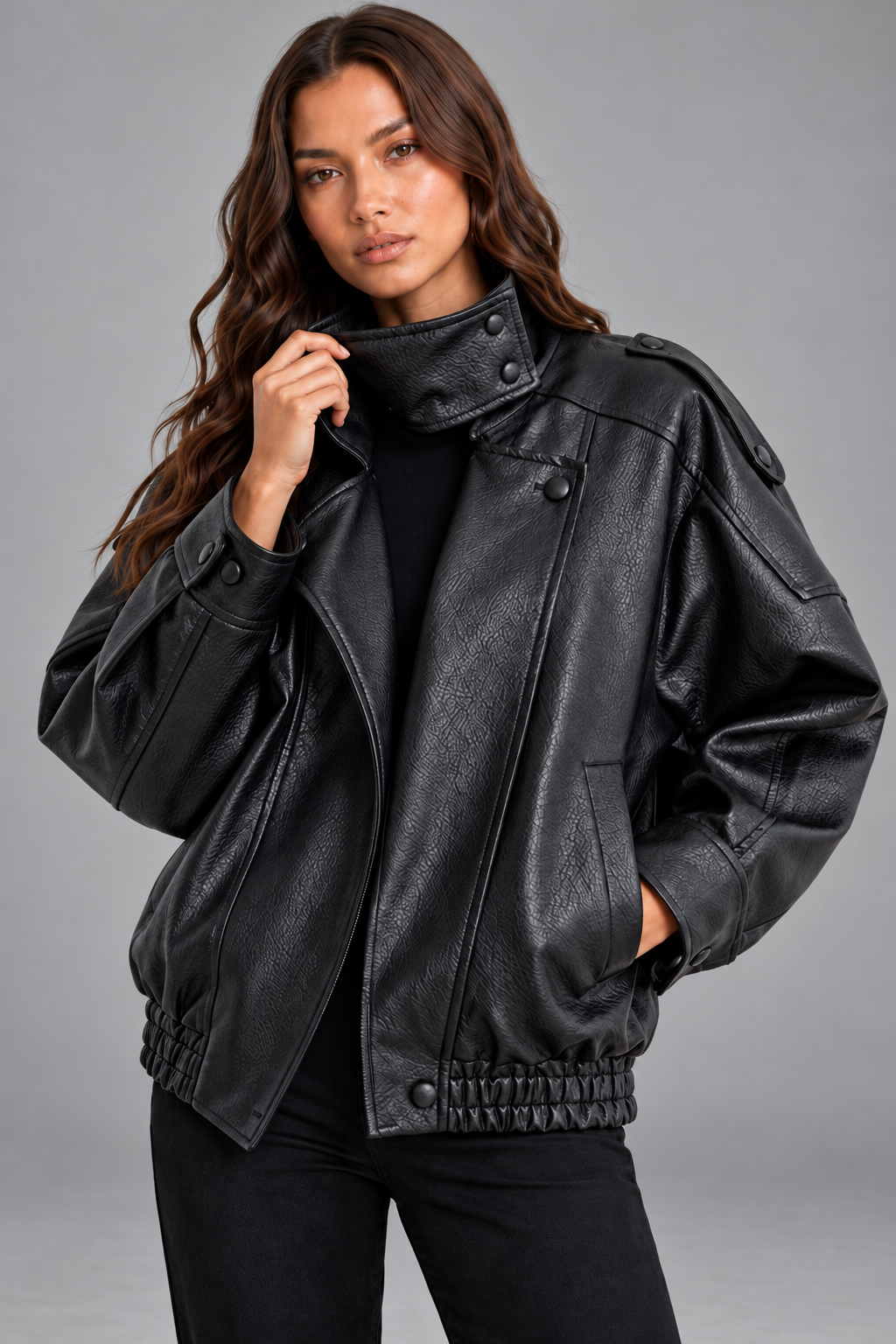 Close-up of black faux leather jacket funnel collar and front zip