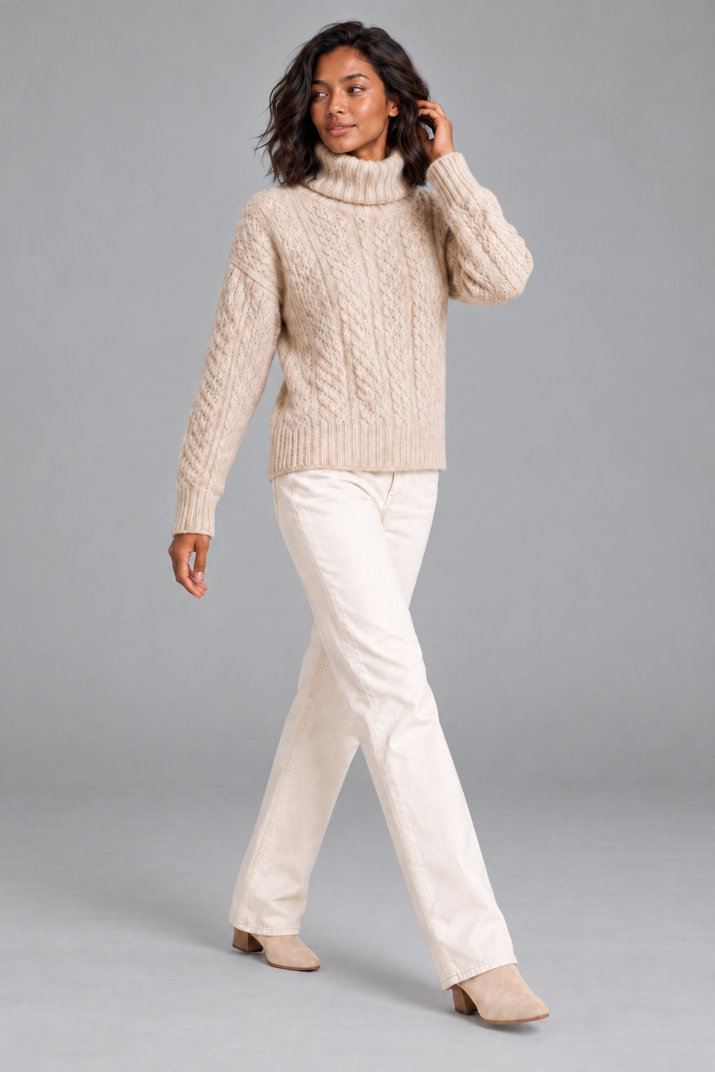 Women's beige cable knit turtleneck sweater, full-length walking look