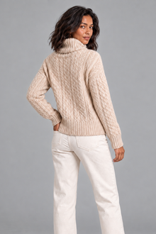 Women's beige cable knit turtleneck sweater, back view