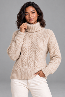 Women's beige cable knit turtleneck sweater, front view