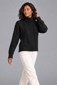 Women's black cable knit turtleneck sweater, front view