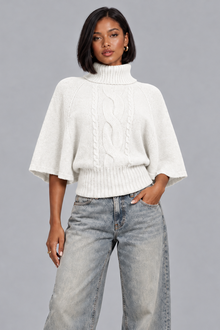Women's white cable knit turtleneck jumper with cape sleeves, front view