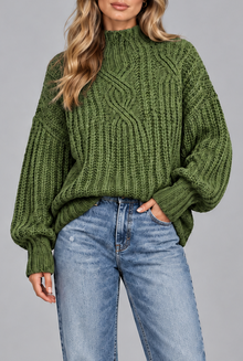 Women's green chunky cable knit jumper, front view