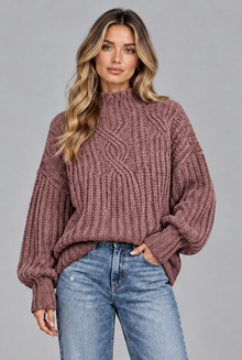 Women's pink chunky cable knit jumper, front view