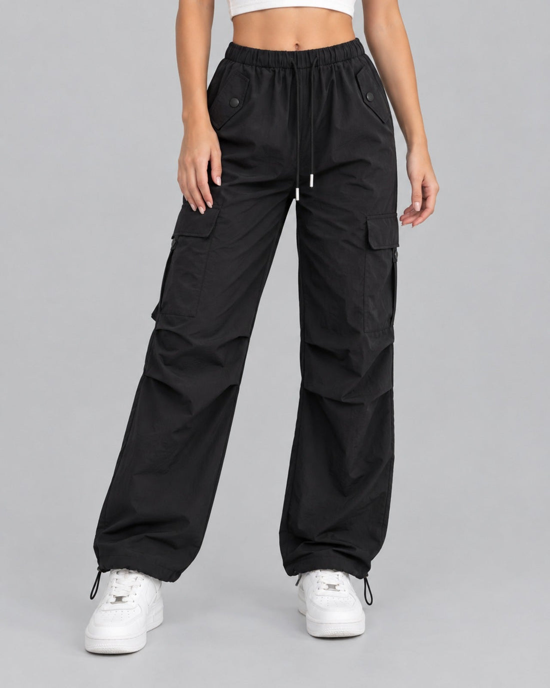 Women's pink cotton parachute cargo trousers with drawstring waist, front view