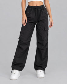 Women's black cotton parachute cargo trousers with drawstring waist, front view