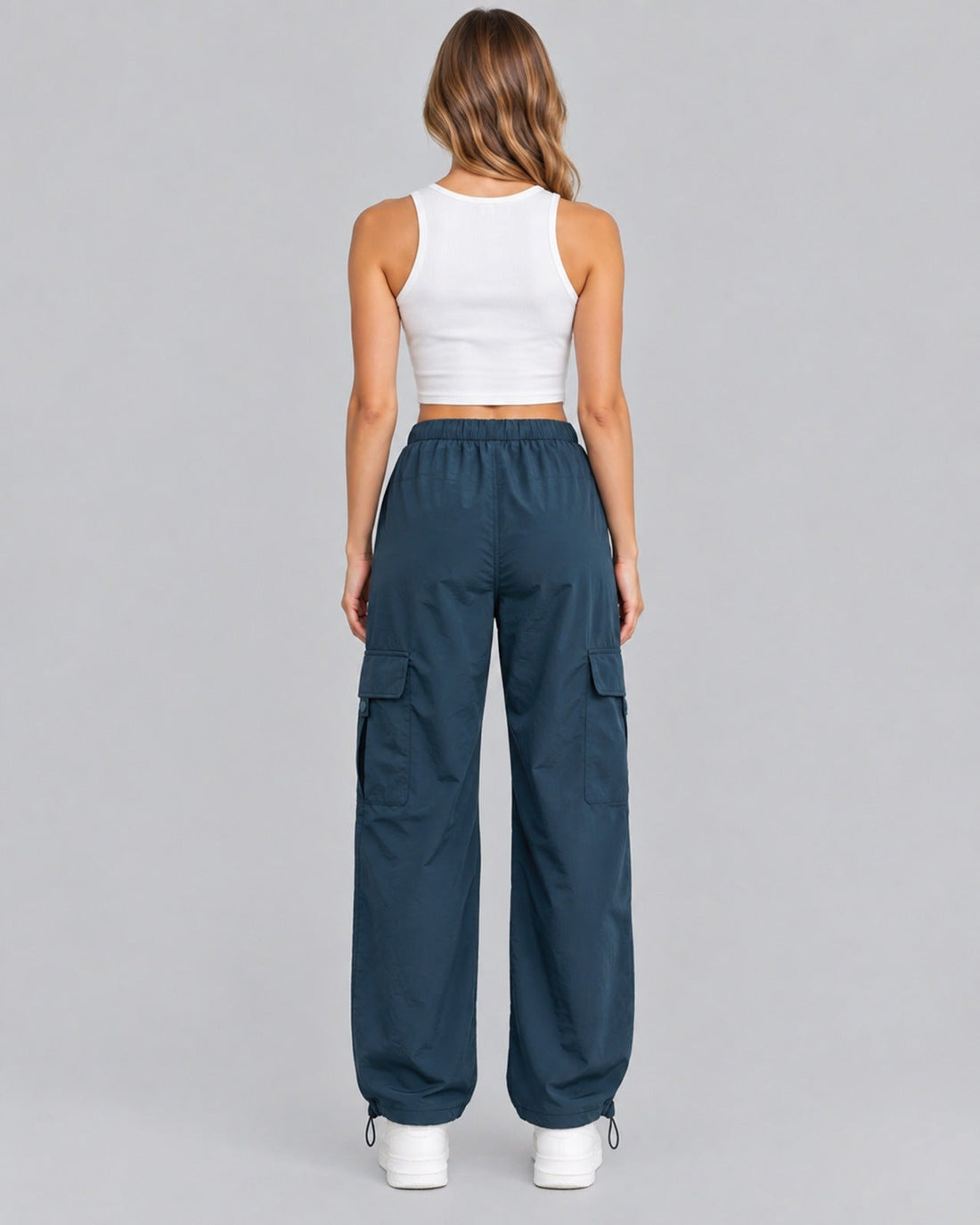Blue cotton cargo trousers with white crop top, back view