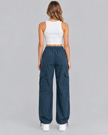 Blue cotton cargo trousers with white crop top, back view