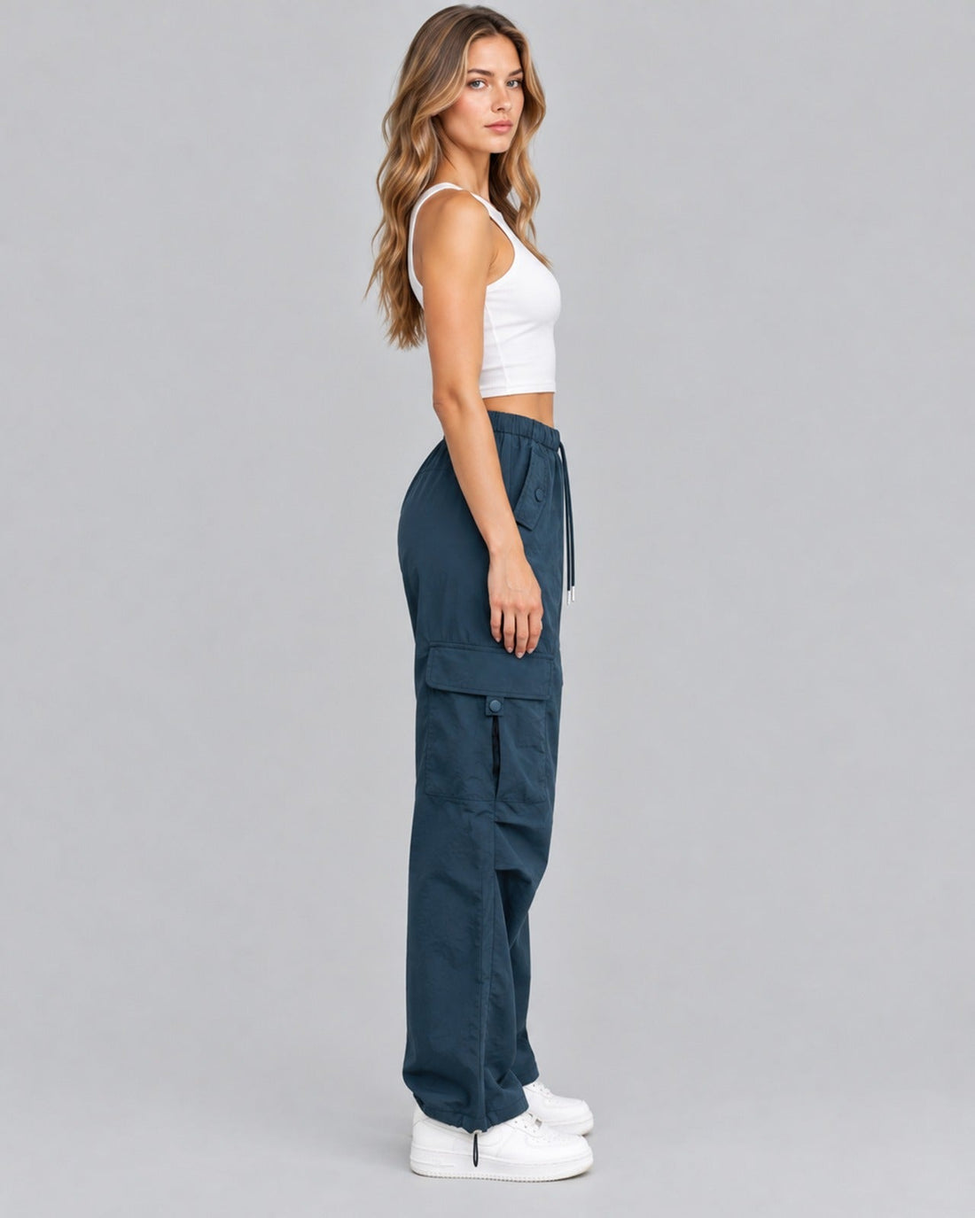 Blue cotton cargo trousers with white crop top, side view showing cargo pocket