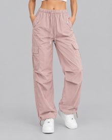 Women's pink cotton parachute cargo trousers with drawstring waist, front view