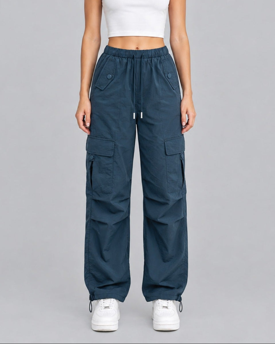 Model wearing blue cotton cargo trousers with white crop top, full-length front view