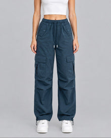 Model wearing blue cotton cargo trousers with white crop top, full-length front view