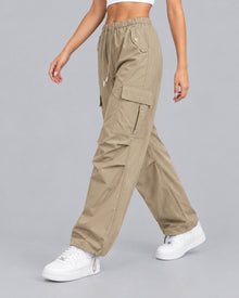 Women's brown cotton parachute cargo trousers with drawstring waist, front view