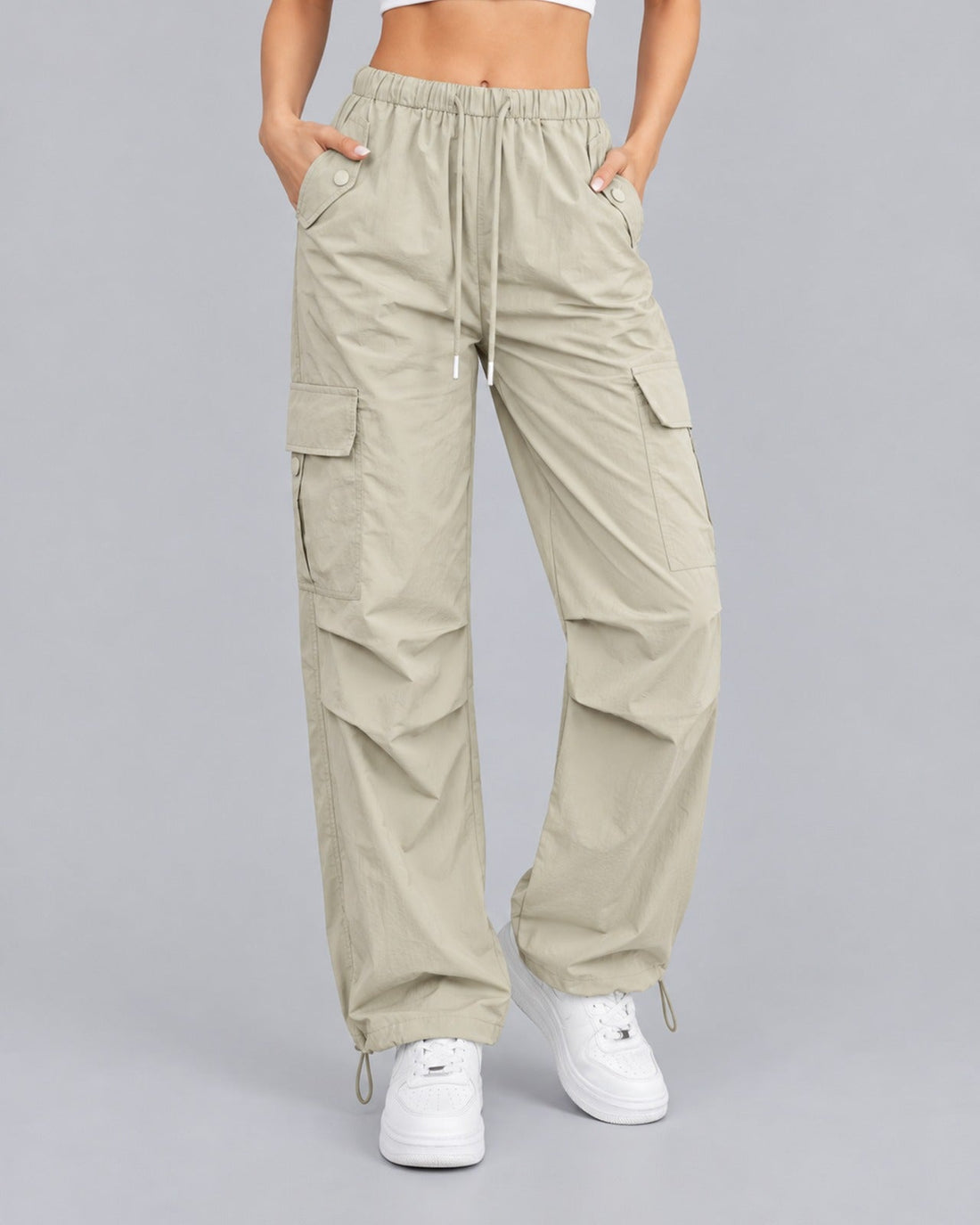 Women's khaki cotton parachute cargo trousers with drawstring waist, front view