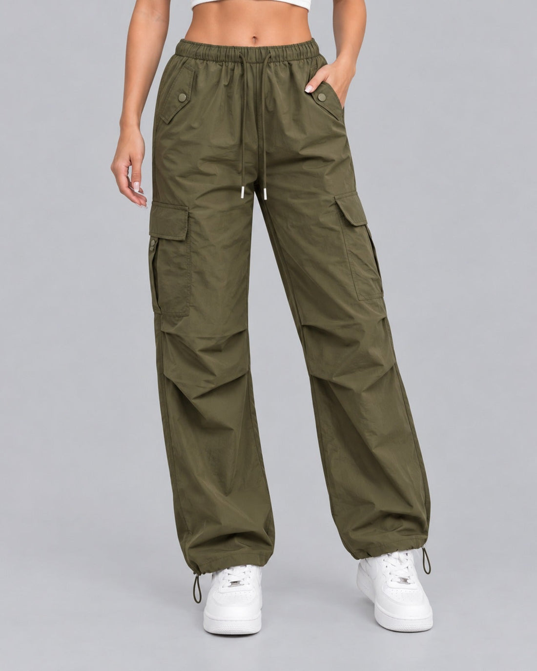Women's green cotton parachute cargo trousers with drawstring waist, front view