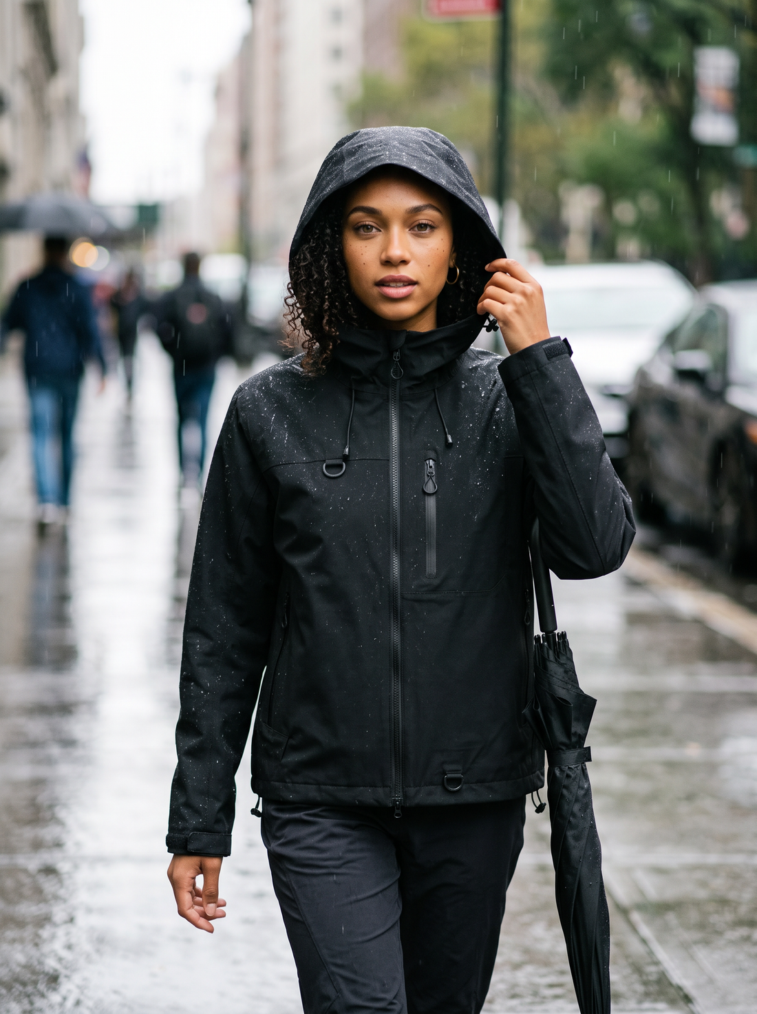 Women's Short Hooded Waterproof Raincoat in Black – lifestyle shot