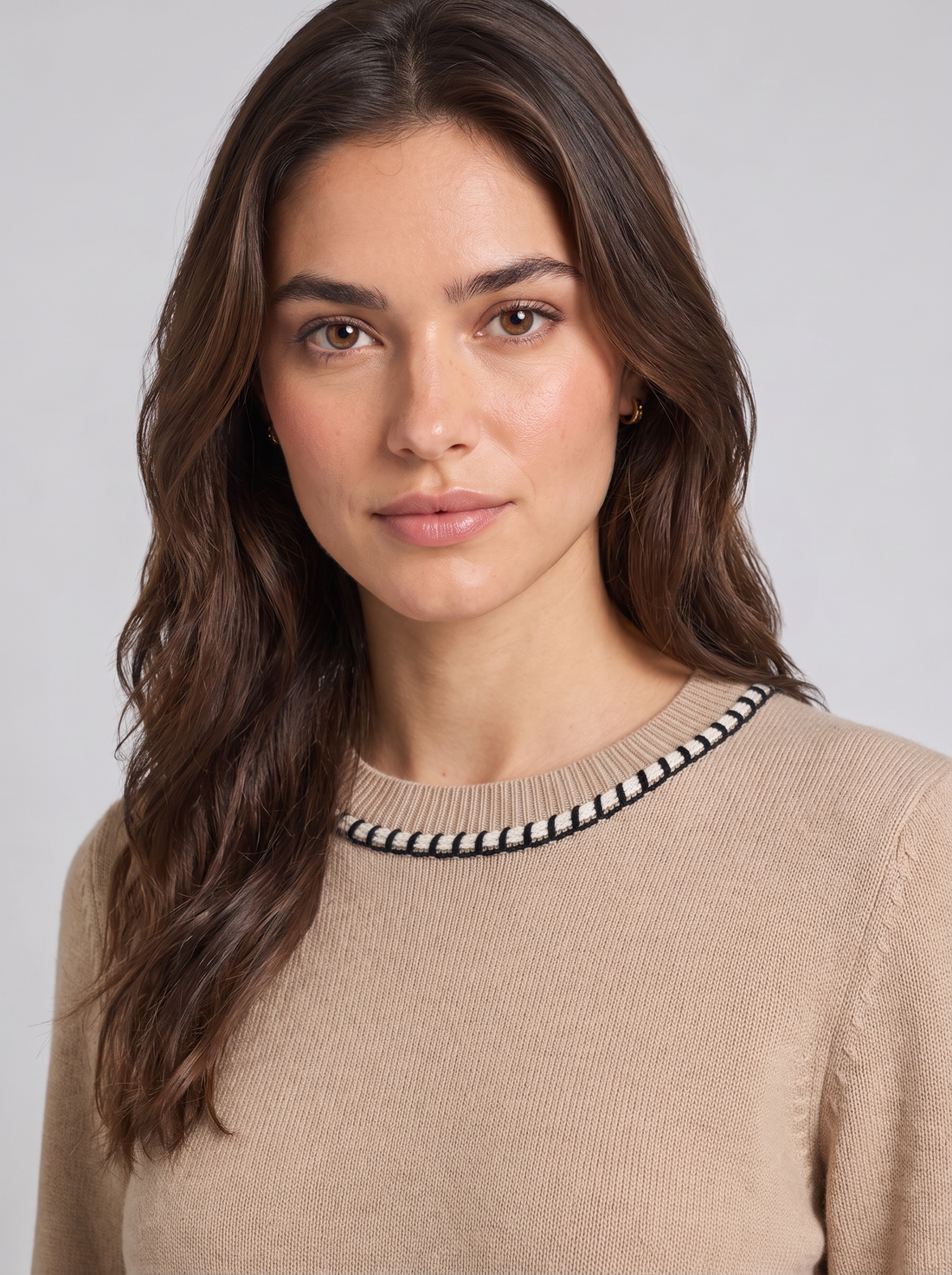 Beige knitted jumper, neckline trim close-up