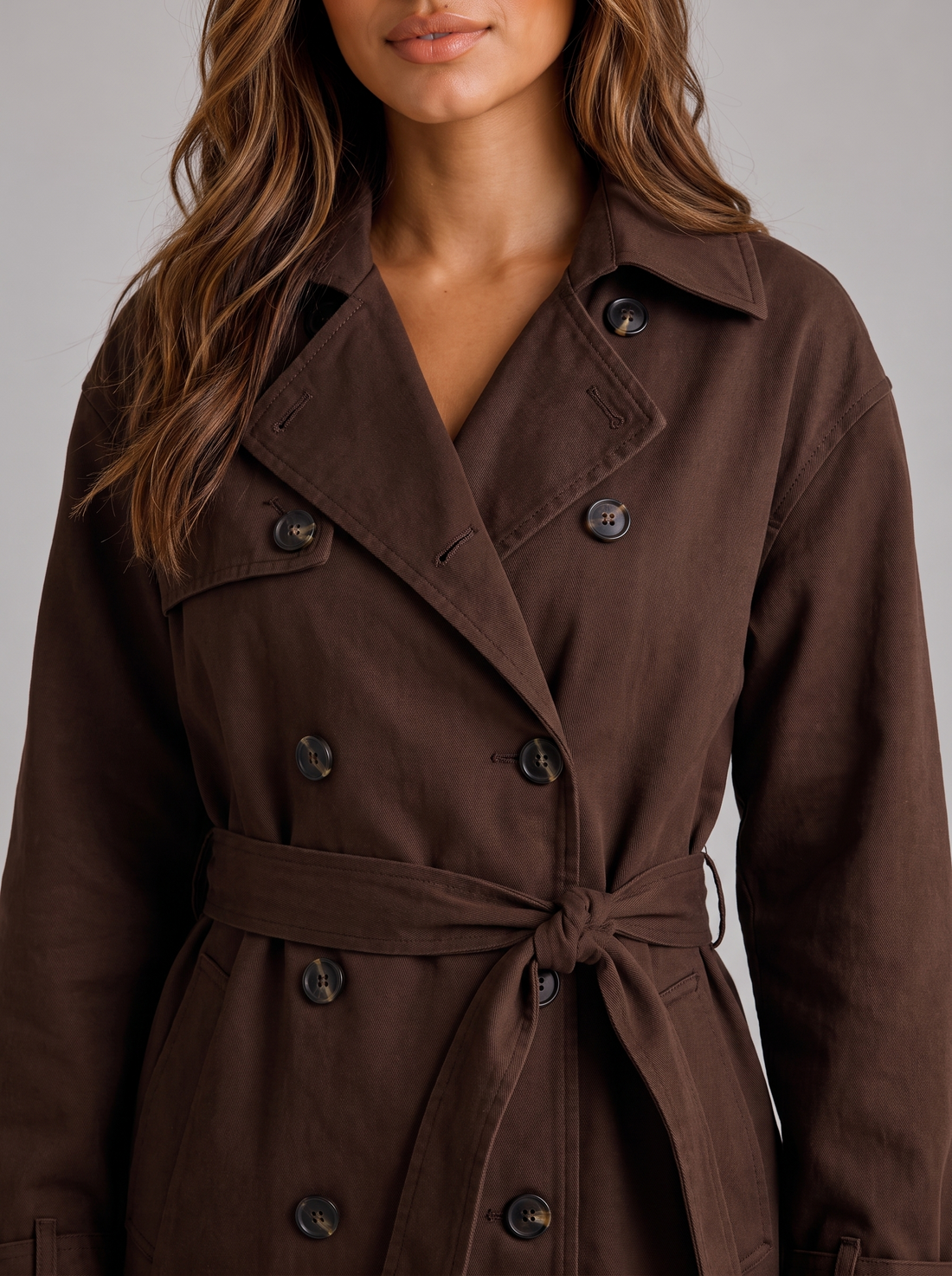 Women's cropped trench jacket in brown, waist and lapel close-up