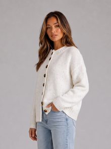 Model wearing ivory white fluffy knit button front cardigan, side view