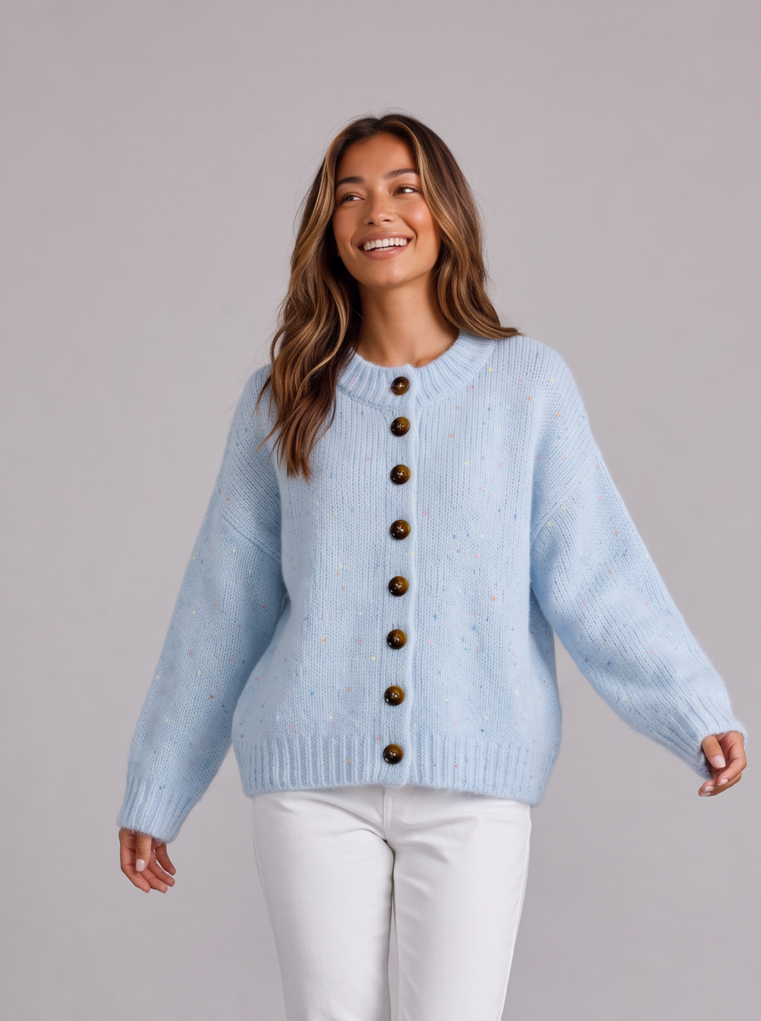Woman wearing light blue fluffy knit button-front round neck cardigan with white jeans