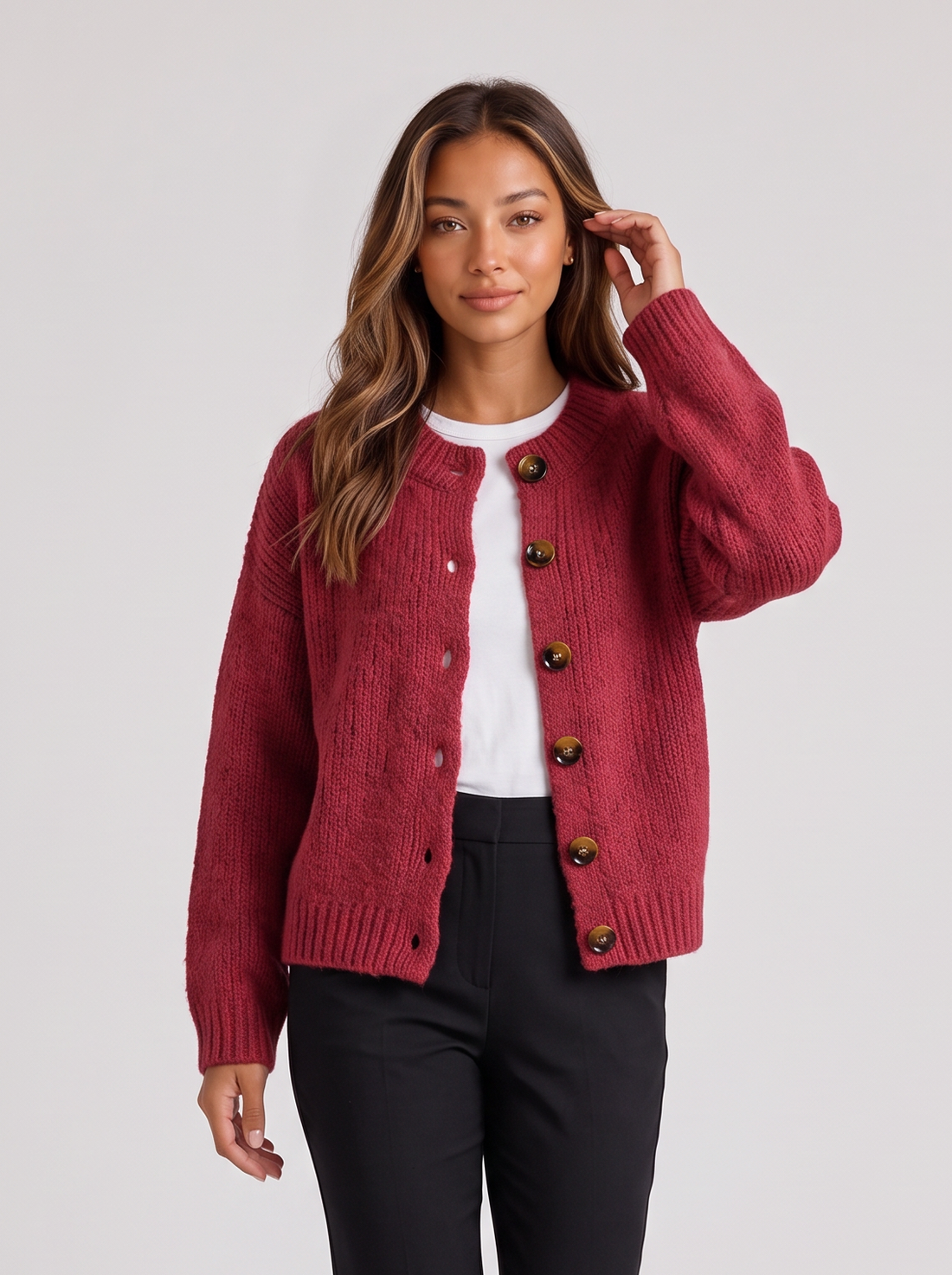 Woman wearing red rose fluffy knit button-front round neck cardigan with black trousers