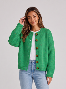 Woman wearing green fluffy knit button-front round neck cardigan with light blue jeans
