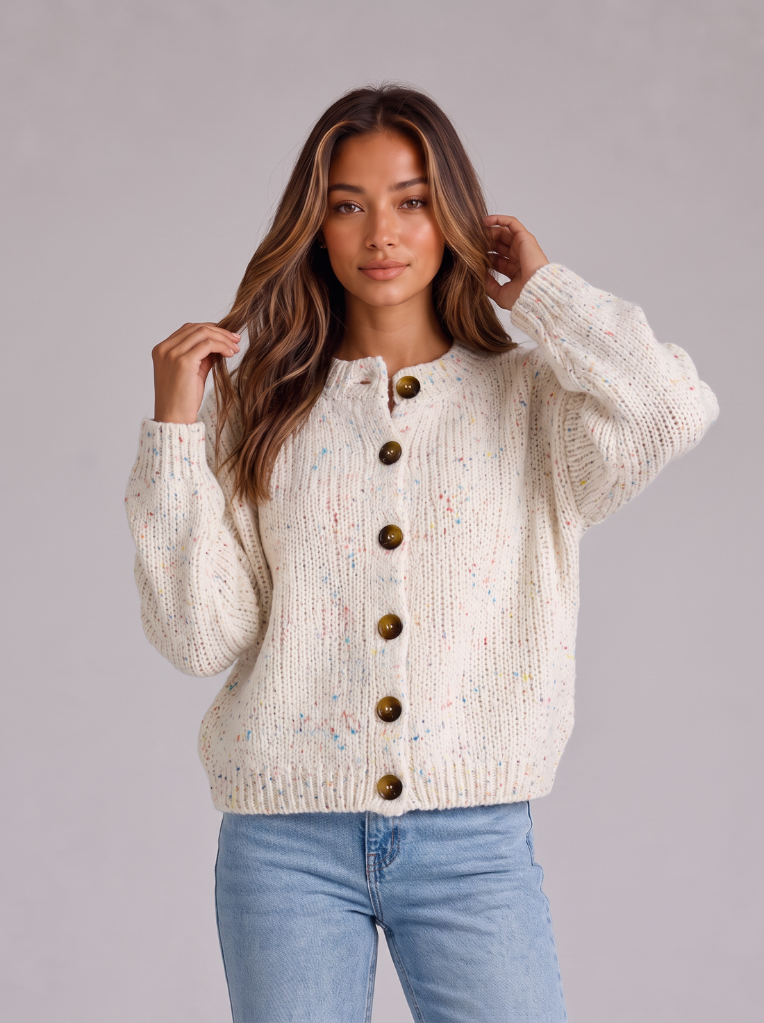 Woman wearing milky off-white fluffy knit button-front round neck cardigan with light blue jeans