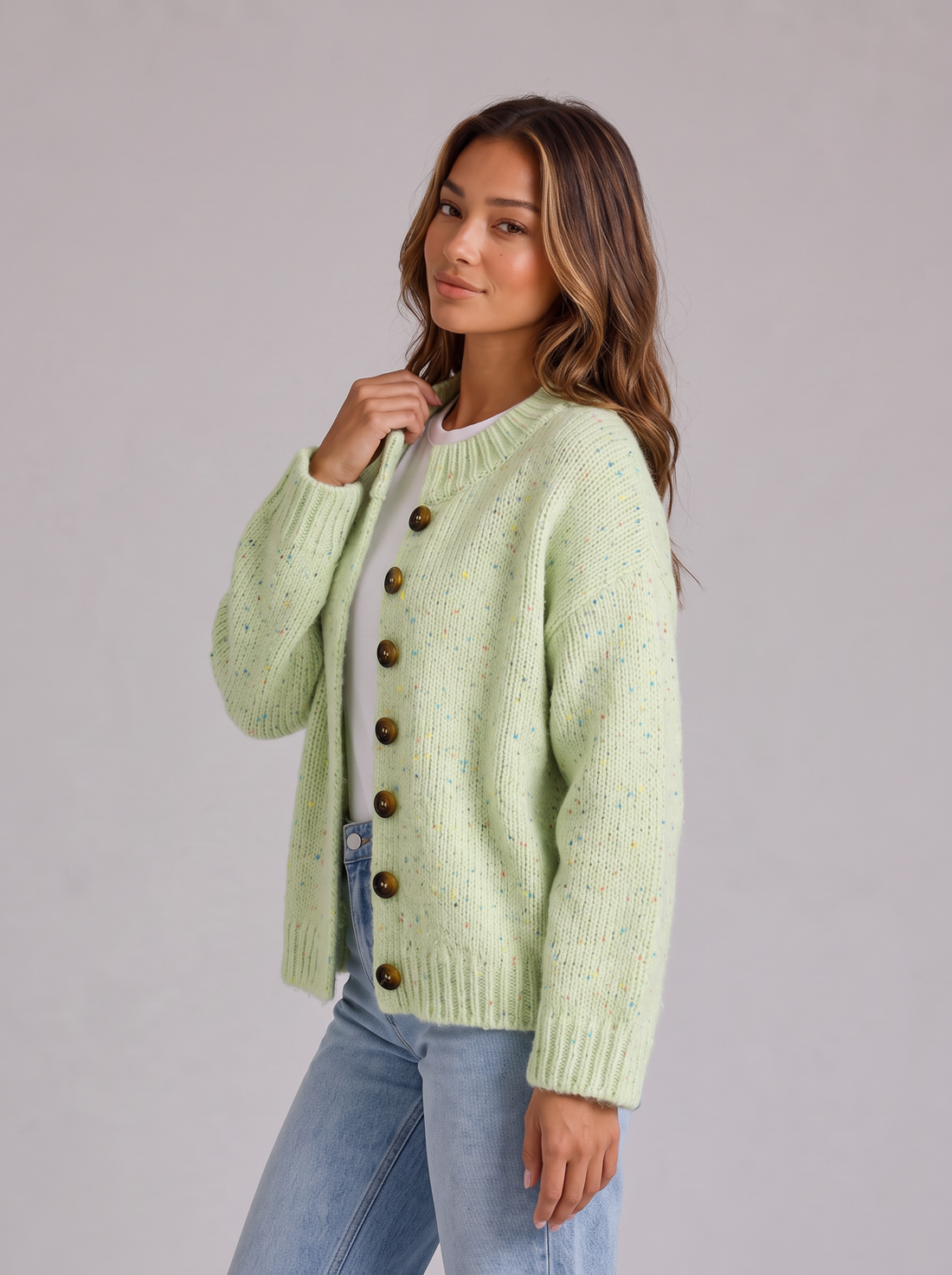 Woman wearing green pinellia fluffy knit button-front round neck cardigan looking over her shoulder