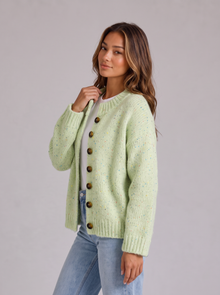 Woman wearing green pinellia fluffy knit button-front round neck cardigan looking over her shoulder