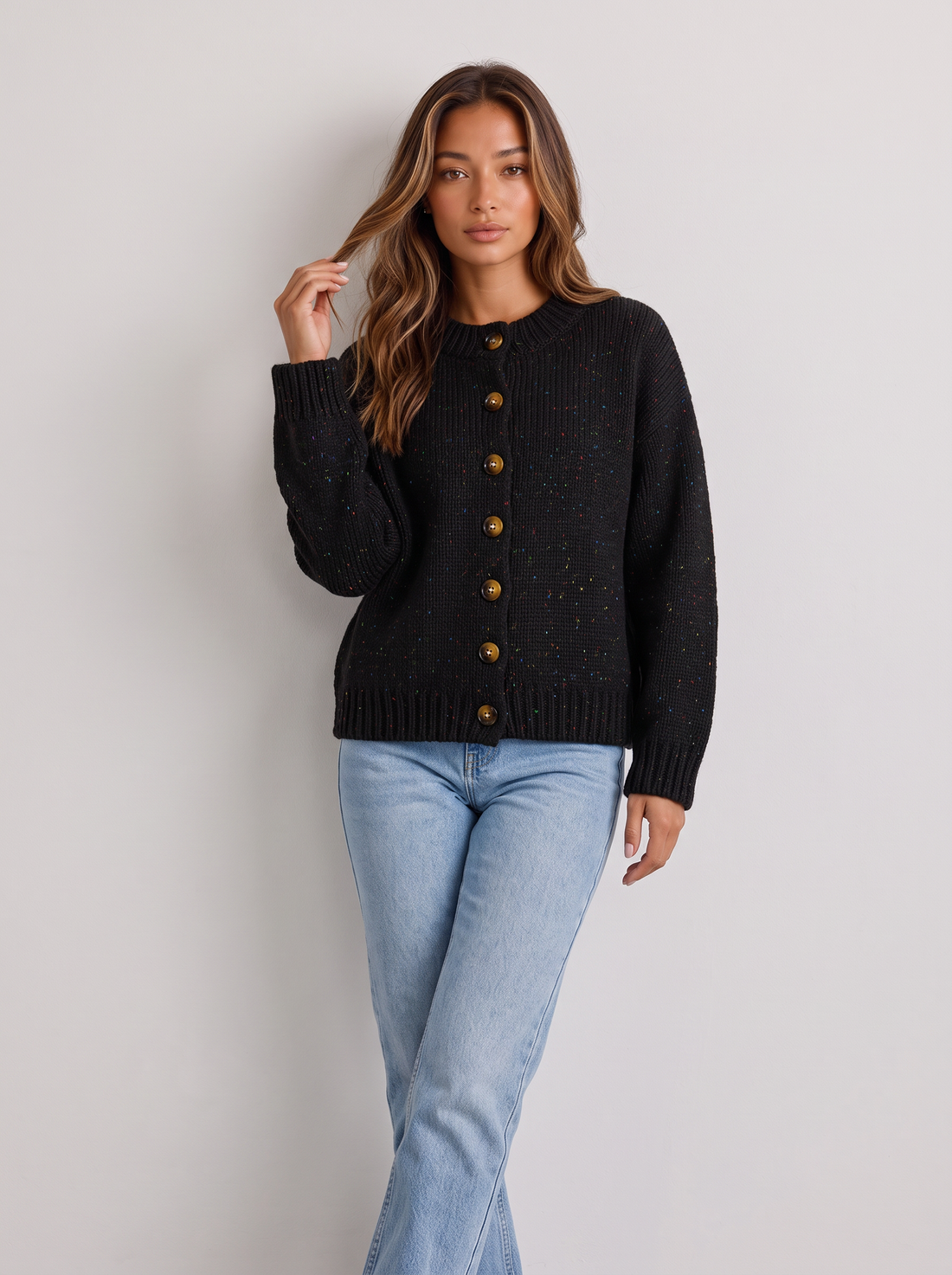 Woman wearing black fluffy knit button-front round neck cardigan with light blue jeans