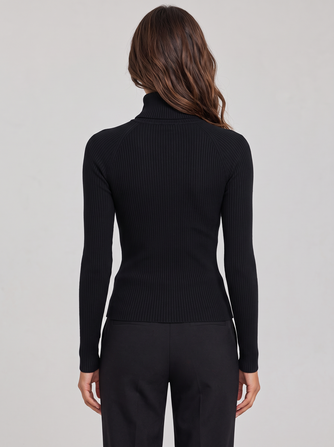 Woman wearing black ribbed roll neck long sleeve top with collar zip, front view