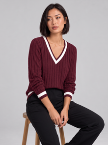 Woman wearing ribbed V-neck contrast trim jumper in burgundy