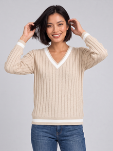 Woman wearing ribbed V-neck contrast trim jumper in apricot