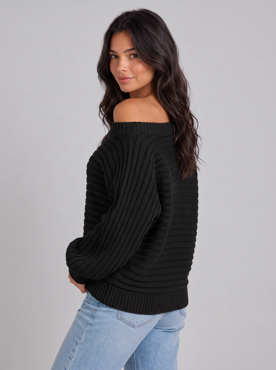 Woman wearing black off-shoulder ribbed batwing jumper