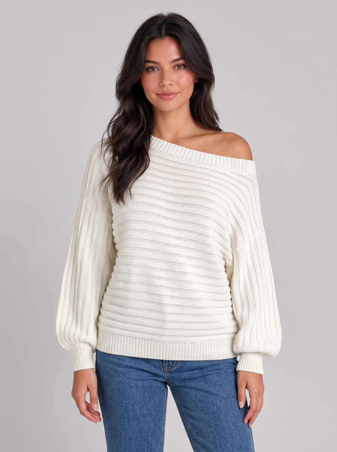 Woman wearing white chunky ribbed off-shoulder batwing jumper, front view
