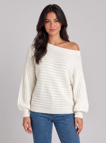 Woman wearing white chunky ribbed off-shoulder batwing jumper, front view