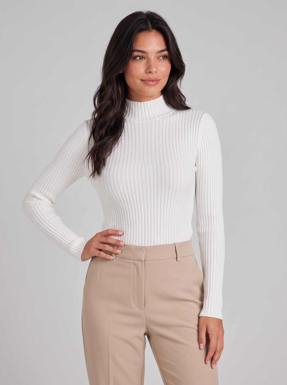 Woman wearing white slim fit ribbed mock neck jumper