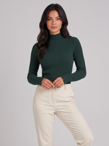 Woman wearing dark green slim fit ribbed mock neck jumper
