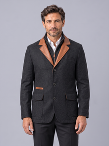 Man wearing black vintage field jacket with tan contrast trim, front view