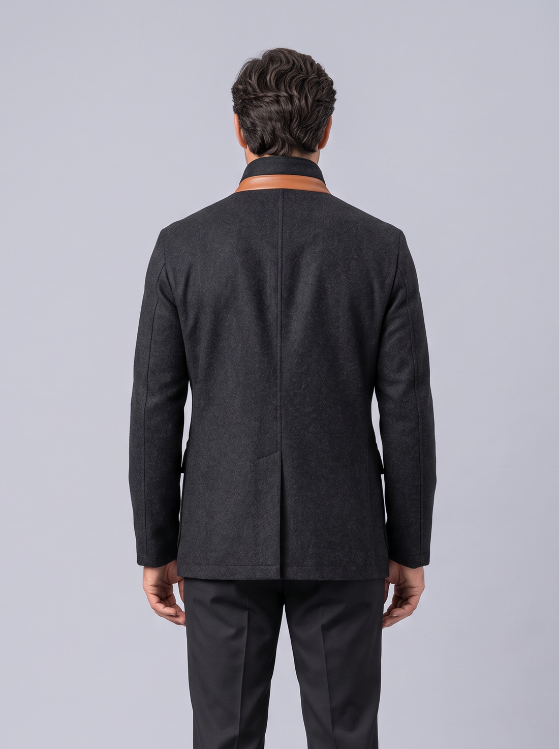 Man wearing black vintage field jacket with tan contrast trim, front view
