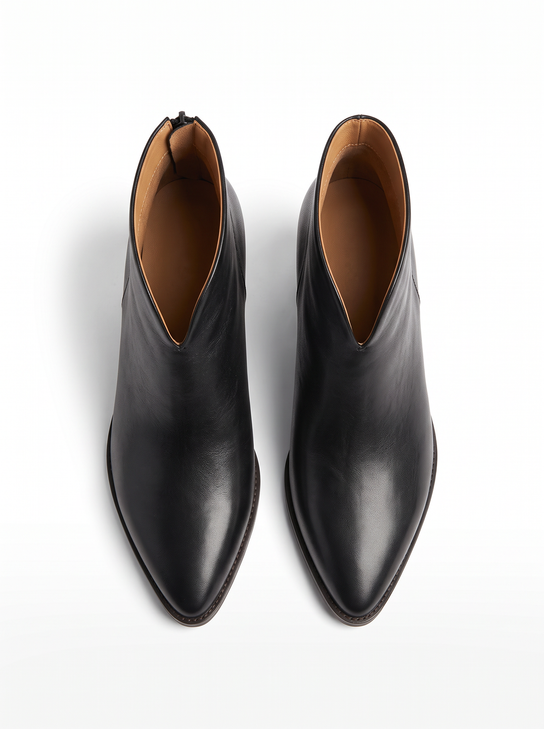 Top view of a pair of black pointed toe ankle boots