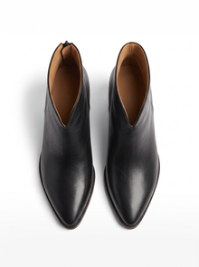 Top view of a pair of black pointed toe ankle boots