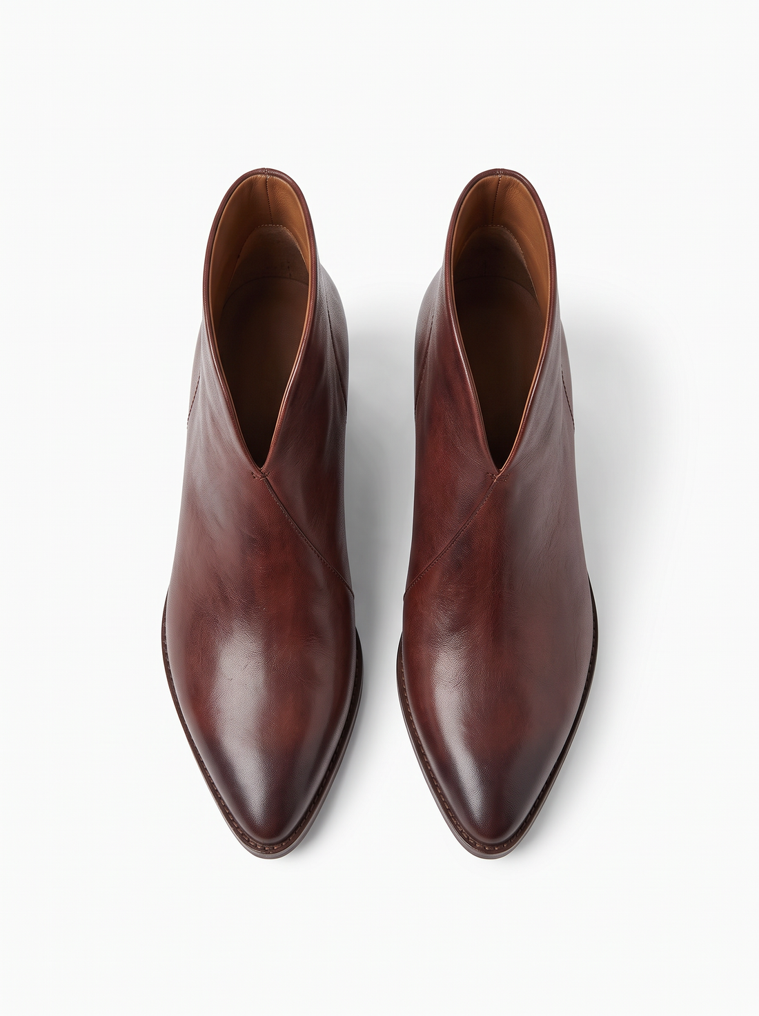 Top view of a pair of brown pointed toe ankle boots