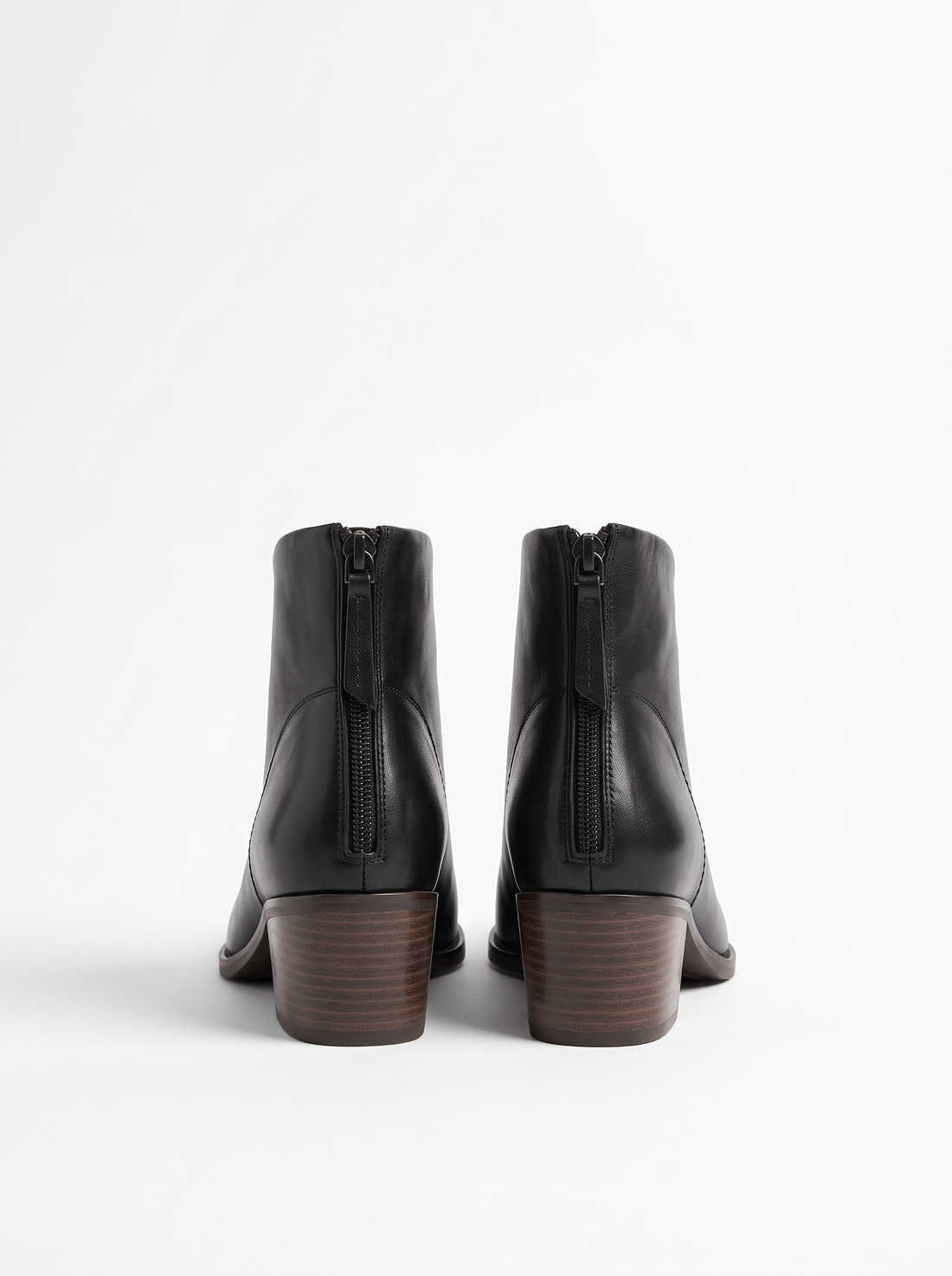 Back view of black ankle boots showing back zip and stacked heel
