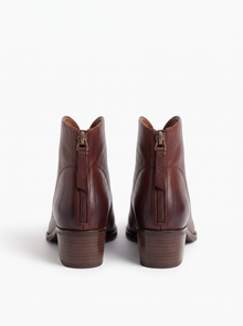 Back view of brown ankle boots with back zip and block heel
