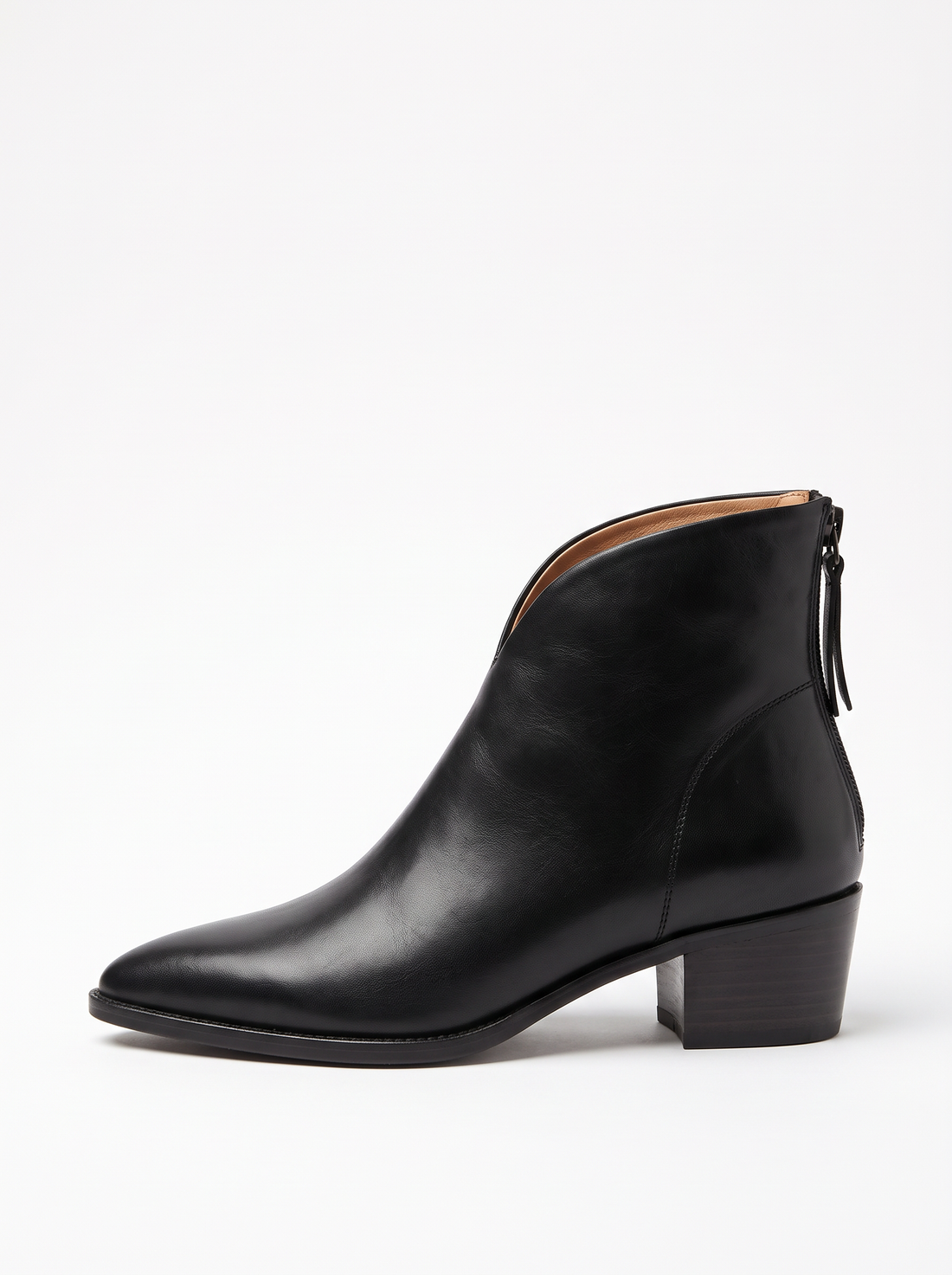 Women's black vegan leather pointed toe ankle boots with low block heel, worn, three-quarter view