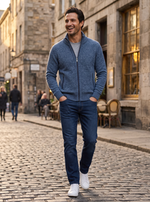 Man walking in city street wearing blue merino full-zip cardigan