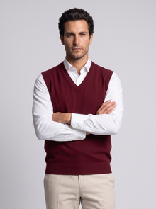 Man with arms crossed in burgundy merino wool sweater vest