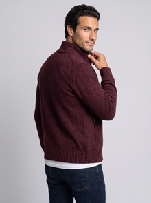 Man looking over shoulder in burgundy merino wool full-zip cardigan